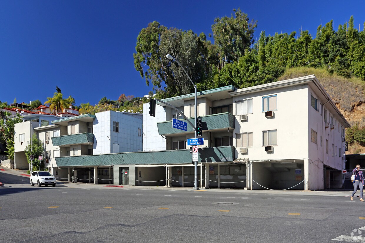 Corner multifamily property on a busy boulevard with ground-level retail