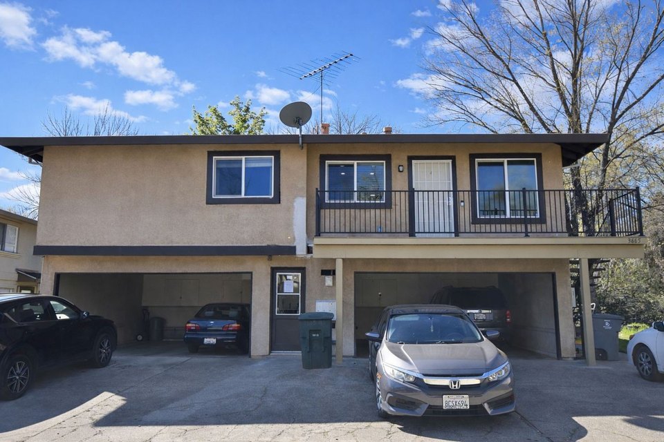 Duplex-style multifamily with carport parking and private balcony