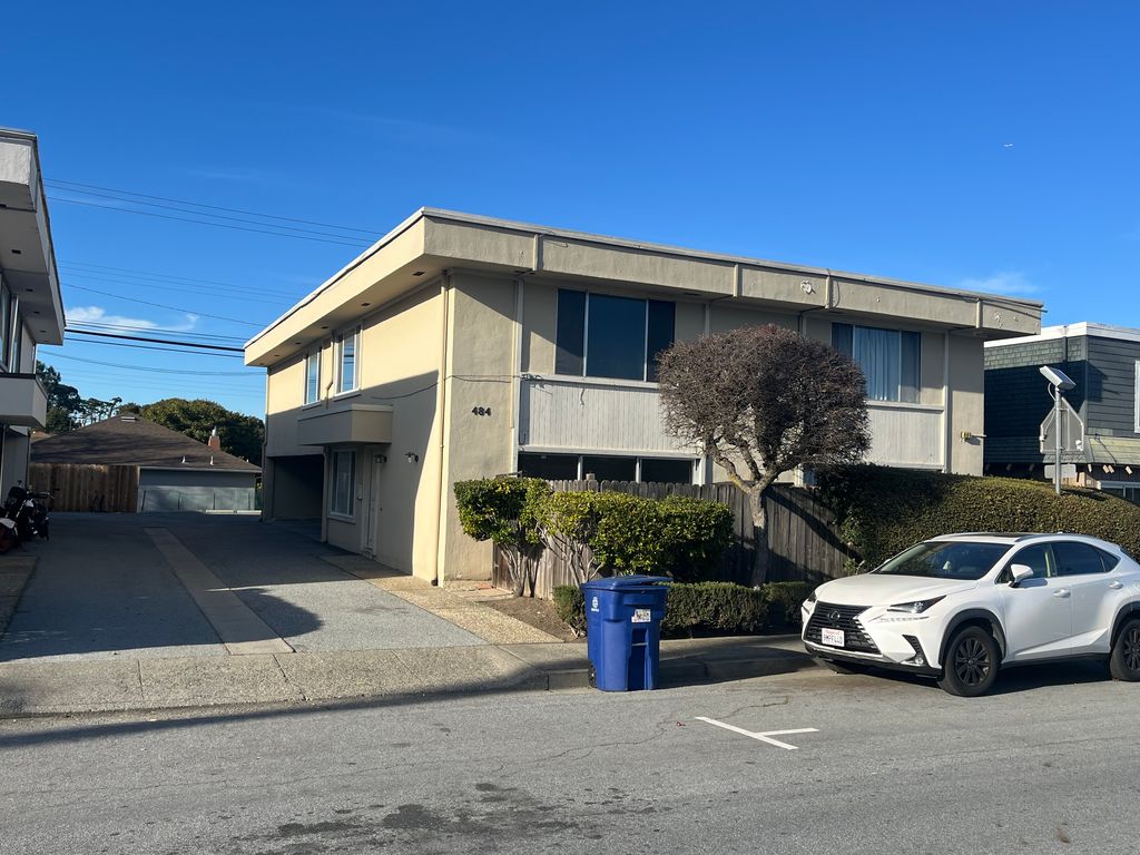 Corner apartment property with mature shade trees and curb appeal