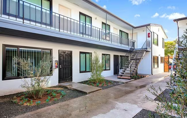Mid-rise apartment building with clean lines and street-level entry